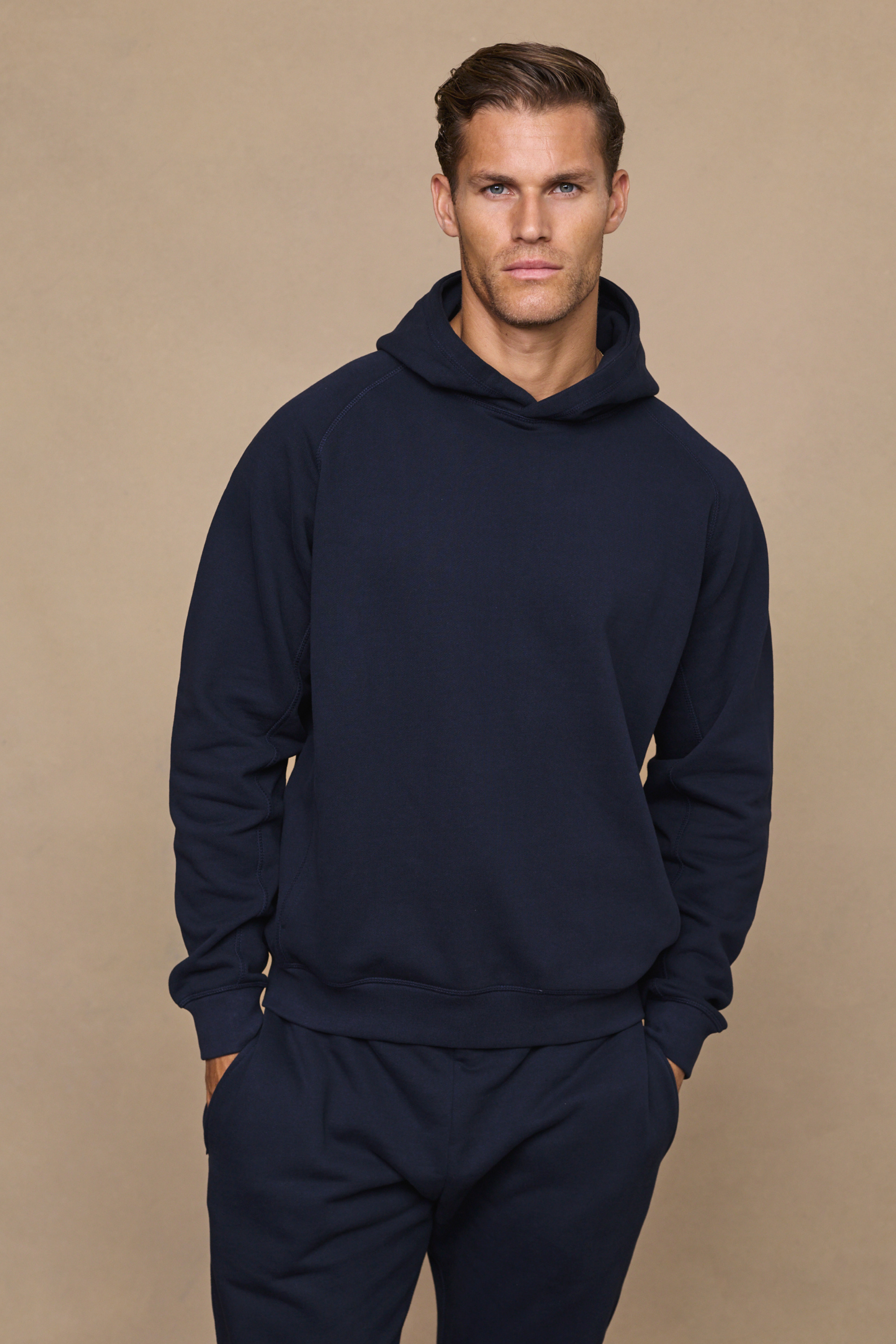 Men’s heavyweight cotton blend hoodie in navy with raglan sleeves by Raith